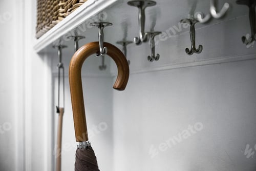 Preview: Umbrella Hangs on Hooks in a White Room