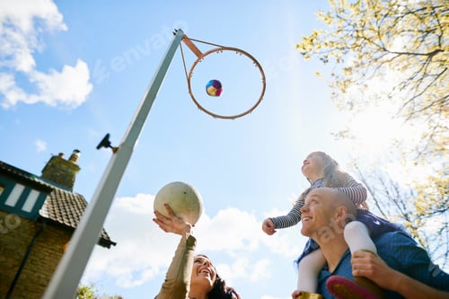 Preview: Family throwing basketball through basketball hoop