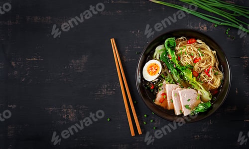 Preview: Miso Ramen Asian noodles with egg, pork and pak choi cabbage in bowl on dark background.