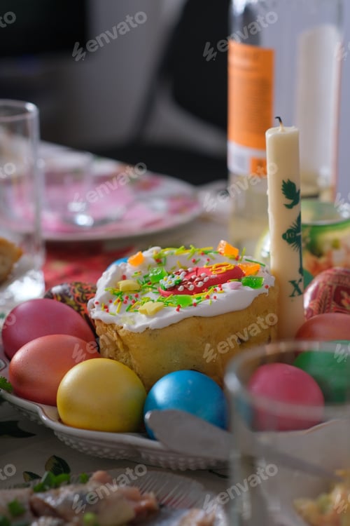 Preview: Ukrainian Easter festive dishes. Festive table setting. Bright colored eggs, cake Paska