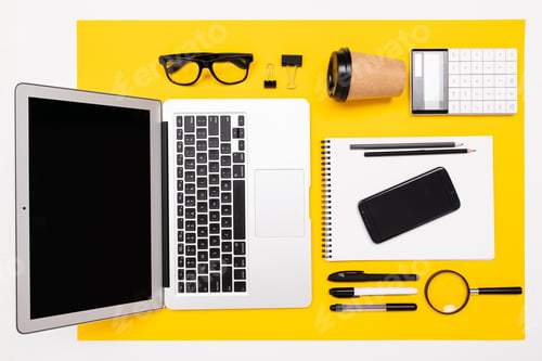 Preview: School and office supplies lie neatly on a yellow background