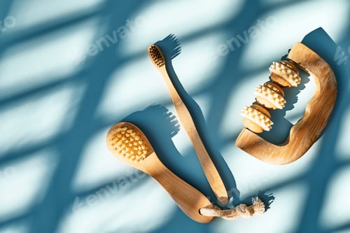 Preview: Waste-free bathroom accessories on light blue background with geometric shadows.