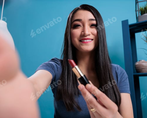 Preview: Pov of attractive vlogger holding lipstick reviewing cosmetics product