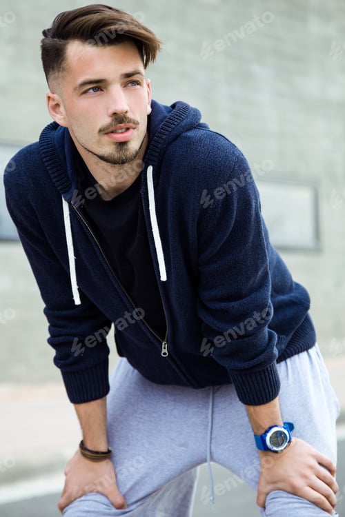 Preview: Tired sportsman resting after exercises
