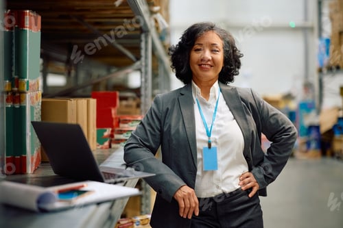 Preview: Happy female warehouse manager at work looking at camera.