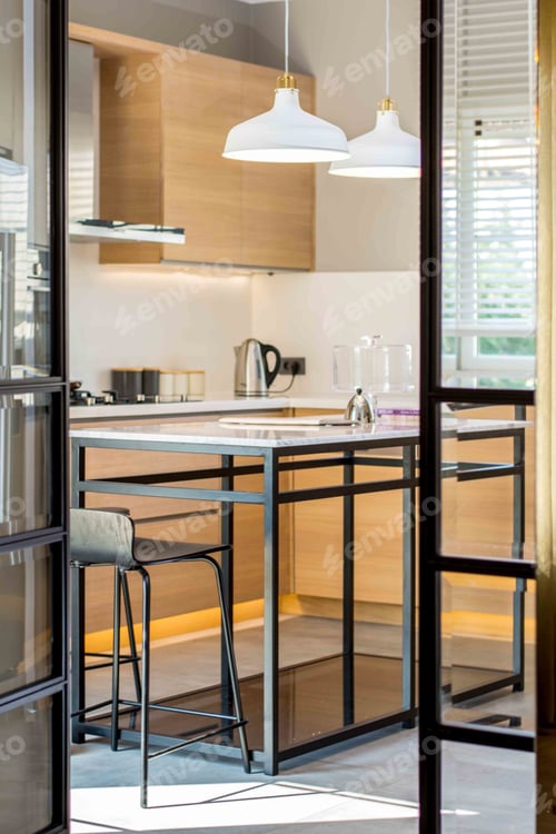 Preview: Vertical shot of a high table with bar chairs in the kitchen of a modern apartment