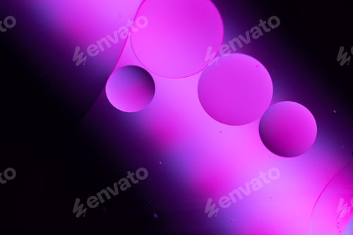 Preview: Movement of oil bubbles in the liquid in the top view. Oil surface, multicolored background.