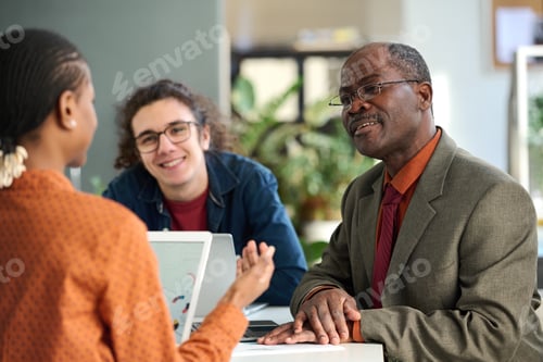 Preview: Smiling Senior Man in Business Meeting