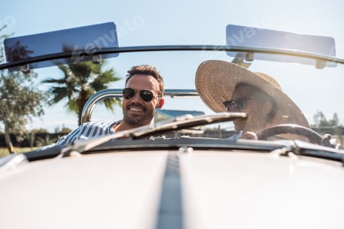 Preview: Multiracial couple in a convertible vintage car