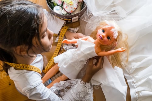 Preview: Little girl dressmaker working in atelier