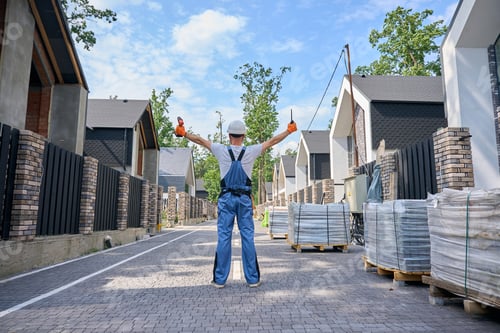 Preview: Construction worker with building tools on development site