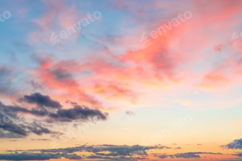 Preview: Blue sky with clouds at sunset in pink colors