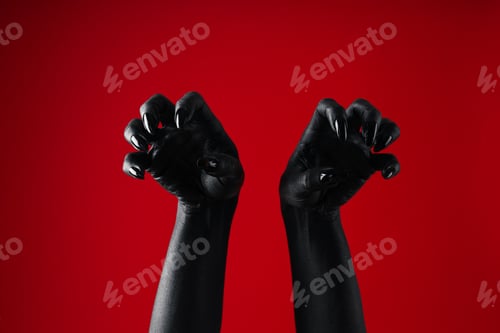 Preview: Black female hands with black manicure on red background