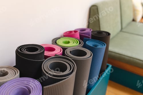 Closeup of rolled up colorful exercise mats in yoga studio