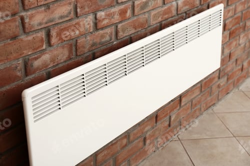 Preview: Modern heating convector on brick wall indoors