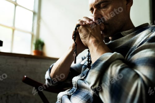 Preview: Cloesup of hands holding cross praying