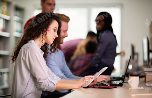 Preview: Colleagues working together in company office