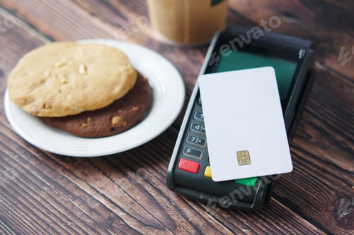 Preview: contactless payment concept with young man paying with credit card
