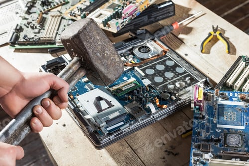 Preview: Male hands with sledgehammer brakes laptop closeup