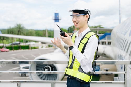 Preview: Male aviation engineer in safety gear inspecting an airplane engine, embodying professionalism
