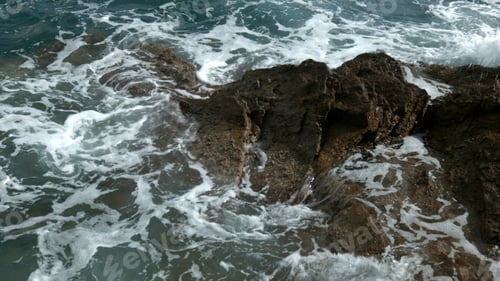 Preview: Beautiful view of the sea beating against the rocks.Creative.Beautiful large mountains on which