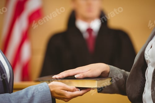 Preview: Witness Swearing On The Bible Telling The Truth In The Court Room