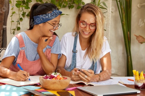 Two Young Women Working Together at Cafe