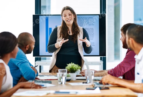Preview: Cropped shot of a young female designer giving a presentation in the boardroom