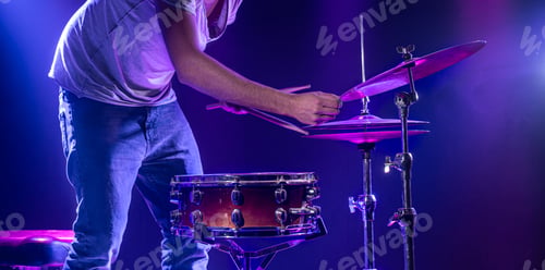 Preview: A drummer plays drums on a blue background. Beautiful special effects of light and smoke.