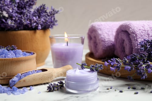 Preview: Cosmetic products and lavender flowers on white marble table