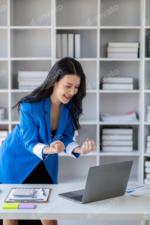 Preview: Beautiful Asian woman looking at data and showing happy expression, businesswoman is delighted to se