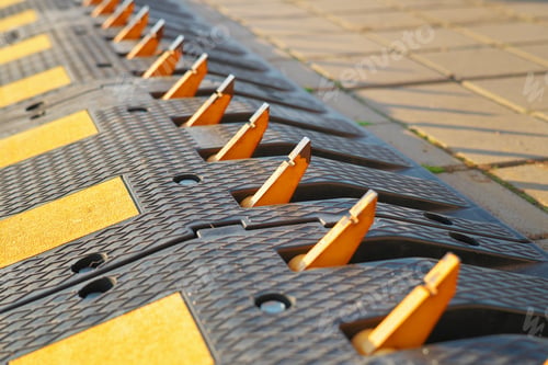 Preview: One way traffic speed bump with spikes is on the road.