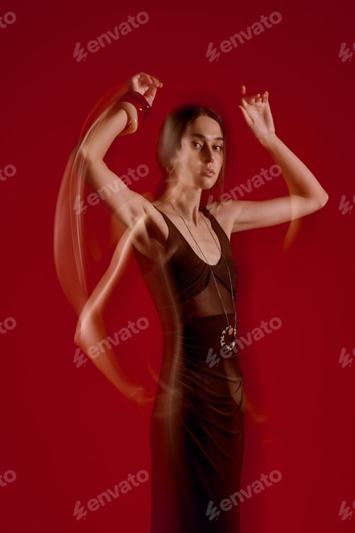 Preview: Fashion forward elegance captured in motion against a striking red backdrop