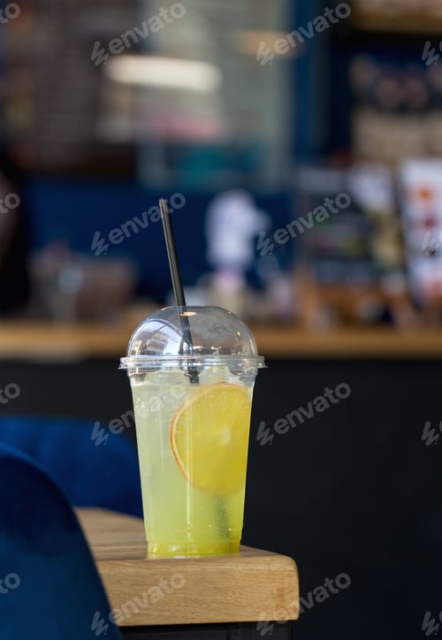 Preview: A glass of refreshing lemon lemonade with a slice of orange on the table