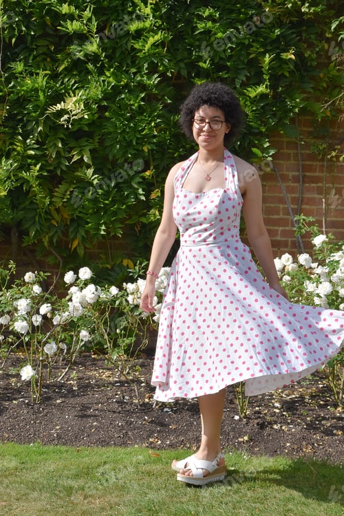 Preview: beautiful mixed race young woman with afro hair, glasses and summer dress