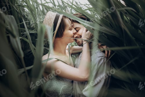 Preview: Happy hipster couple embracing at lake in cane