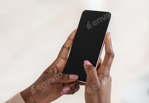 Preview: Modern Smartphone With Black Blank Screen In Hands Of Unrecognizable Black Lady