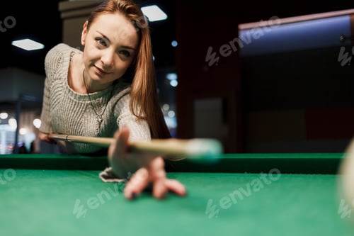 Preview: Concentrated girl while playing billiards