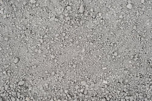 Preview: Gray loose dry soil. Earthy texture background with small lumps, top view