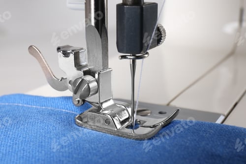 Preview: Modern sewing machine with blue cloth, closeup