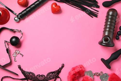 Preview: Frame of different sex toys on pink background, flat lay. Space for text