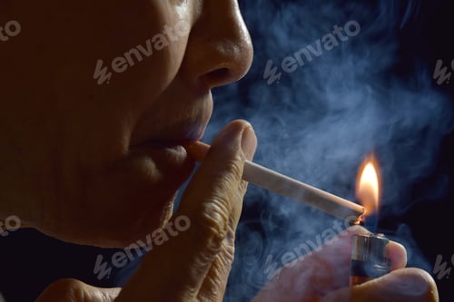Preview: A man lighting a cigarette with a lighter