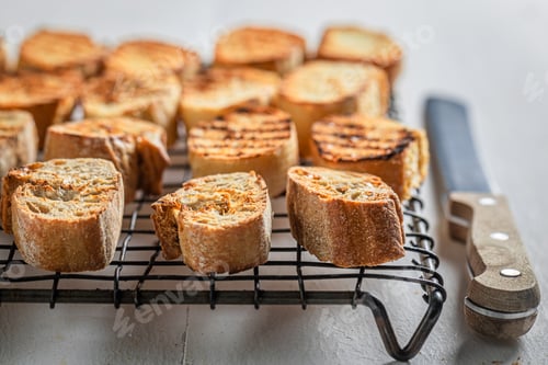Preview: Homemade toasted wholegrain bread on a cooling sheet