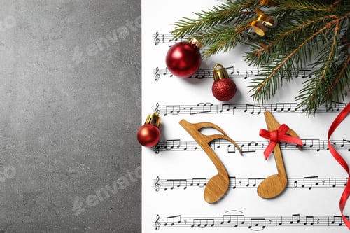 Preview: Christmas decorations, notes and music sheet on grey stone table, flat lay with space for text