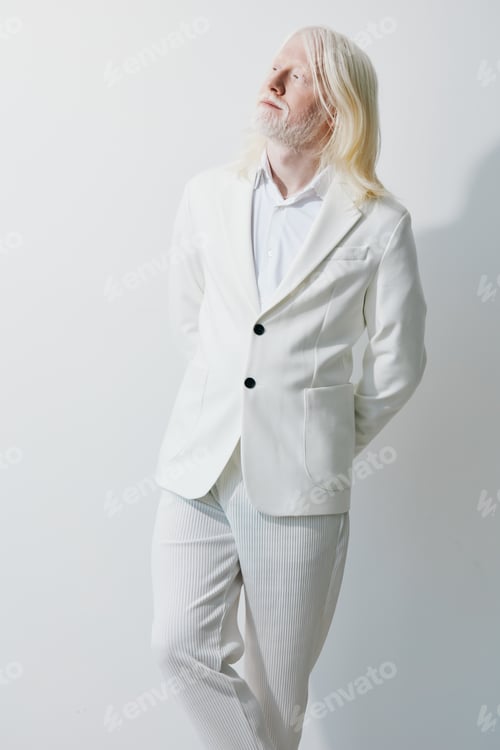 Preview: Elegant man in a stylish white suit against a minimalist white background, exuding confidence and