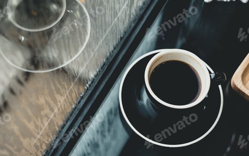 Preview: Black coffee cup on table in cafe restaurant near window