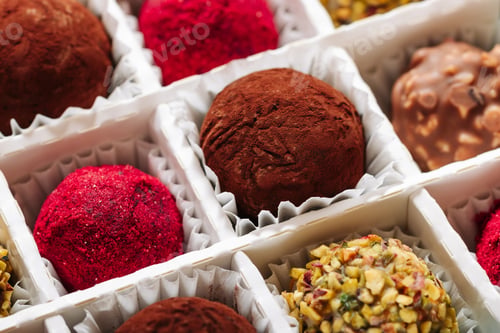 Preview: A set of truffle sweets with different fillings in a box close-up