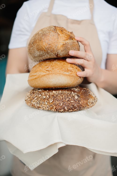 Preview: Shot of an cheerful female baker smiling to the camera standing near the showcase.