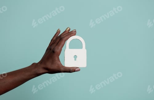 Preview: Black female hand hold concept lock on blue background