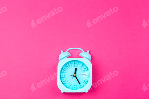 Preview: Alarm clock on color background. Pastel minimalism. Copy space